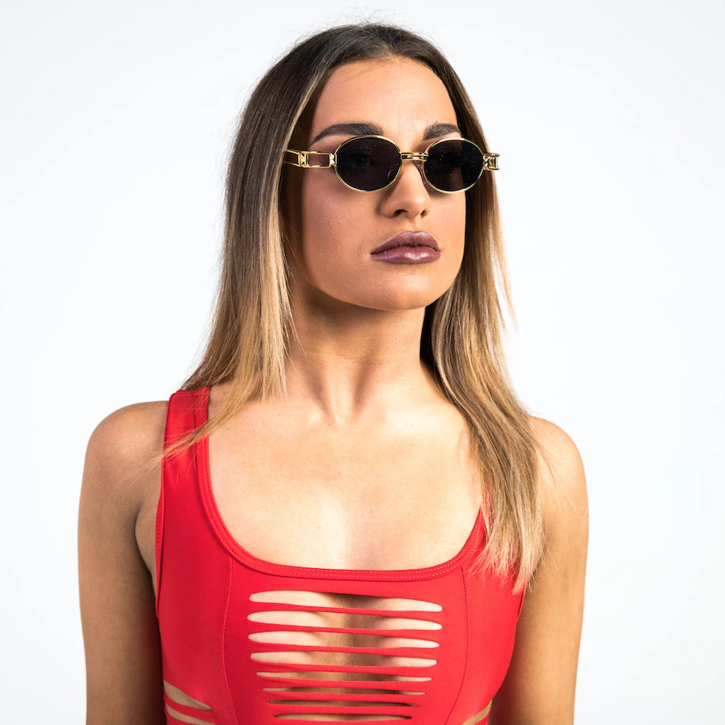 woman wearing gold oval sunglasses